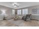 Spacious living room with light beige sectional sofa, recliner, and wood-look floors at 2346 S Banning St, Gilbert, AZ 85295