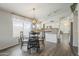 Bright dining room with kitchen views and hardwood floors at 2414 W Gambit Trl, Phoenix, AZ 85085