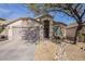 House exterior showcasing a two-car garage and landscaping at 2414 W Gambit Trl, Phoenix, AZ 85085