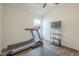 Bright home gym with treadmill, TV, and wood flooring at 2414 W Gambit Trl, Phoenix, AZ 85085