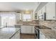 Kitchen boasts granite countertops and white cabinets at 2414 W Gambit Trl, Phoenix, AZ 85085