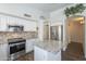 Spacious kitchen, stainless steel appliances, and granite island at 2414 W Gambit Trl, Phoenix, AZ 85085