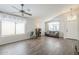 Bright living room with wood-look floors and large windows at 2414 W Gambit Trl, Phoenix, AZ 85085