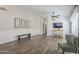 Living room features hardwood floors and a view into the kitchen at 2414 W Gambit Trl, Phoenix, AZ 85085