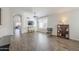 Open living room with wood-look floors and built-in shelving at 2414 W Gambit Trl, Phoenix, AZ 85085