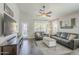 Spacious living room featuring wood-look floors and comfortable seating at 2414 W Gambit Trl, Phoenix, AZ 85085