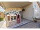 Covered patio with playhouse and brick pavers at 2414 W Gambit Trl, Phoenix, AZ 85085