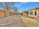 Landscaped backyard with a covered patio and plenty of space for outdoor enjoyment at 26119 W Wahalla Ln, Buckeye, AZ 85396