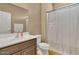 Clean bathroom, featuring a shower/tub combo and dark brown vanity at 26119 W Wahalla Ln, Buckeye, AZ 85396