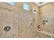 Spacious shower with tiled walls and a built-in seat at 26119 W Wahalla Ln, Buckeye, AZ 85396