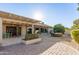 Backyard patio with pergola, landscaping, and a view of the home at 26602 S Nicklaus Dr, Sun Lakes, AZ 85248