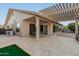 Backyard patio with pergola, putting green, and seating area at 26602 S Nicklaus Dr, Sun Lakes, AZ 85248