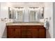 Double vanity bathroom with granite countertops and large mirrors at 26602 S Nicklaus Dr, Sun Lakes, AZ 85248