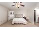 Comfortable bedroom with ceiling fan and access to the bathroom at 26602 S Nicklaus Dr, Sun Lakes, AZ 85248