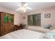 Bedroom with two twin beds, a ceiling fan, and built-in shelving at 26602 S Nicklaus Dr, Sun Lakes, AZ 85248