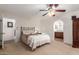 Bright bedroom with ceiling fan and ensuite bathroom access at 26602 S Nicklaus Dr, Sun Lakes, AZ 85248