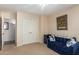 Bedroom with a blue sofa and double door closet at 26602 S Nicklaus Dr, Sun Lakes, AZ 85248