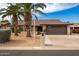 Single-story home with a two-car garage and mature landscaping at 26602 S Nicklaus Dr, Sun Lakes, AZ 85248