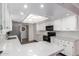 Modern kitchen with white cabinets, granite countertops, and recessed lighting at 26602 S Nicklaus Dr, Sun Lakes, AZ 85248