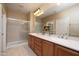 Elegant bathroom with double vanity, large mirror, and shower at 27060 W Ross Ave, Buckeye, AZ 85396