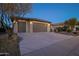 Two-car garage, desert landscaping, and a welcoming front entrance at 27060 W Ross Ave, Buckeye, AZ 85396