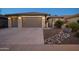 Two-car garage, desert landscaping, and a welcoming front entrance at 27060 W Ross Ave, Buckeye, AZ 85396