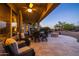 Covered patio with seating area, fire pit, and outdoor dining at 27060 W Ross Ave, Buckeye, AZ 85396