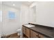 Bright bathroom features a modern vanity with a gray countertop and a window view at 2707 S 357Th Dr, Tonopah, AZ 85354