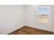 The bedroom has wood flooring and a window at 2707 S 357Th Dr, Tonopah, AZ 85354