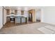 Open kitchen and carpeted living room offer modern living space at 2707 S 357Th Dr, Tonopah, AZ 85354