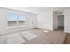Bright, carpeted living room with large windows at 2707 S 357Th Dr, Tonopah, AZ 85354