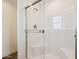 Glass shower with sleek fixtures and built-in seat at 2707 S 357Th Dr, Tonopah, AZ 85354