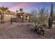 Landscaped front yard with cacti, gravel, and a stone wall at 27627 N 168Th St, Rio Verde, AZ 85263