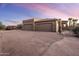 Three-car garage with paver driveway and desert landscaping at 27627 N 168Th St, Rio Verde, AZ 85263