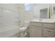 Clean bathroom with tub, toilet, and vanity with storage at 2838 W Apollo Rd, Phoenix, AZ 85041