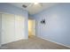 Bedroom with double door closet and wall-mounted TV at 2838 W Apollo Rd, Phoenix, AZ 85041