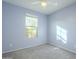 Light blue bedroom with neutral carpeting and ceiling fan at 2838 W Apollo Rd, Phoenix, AZ 85041