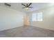 Bedroom with ceiling fan, carpet and door to bathroom at 2838 W Apollo Rd, Phoenix, AZ 85041