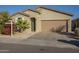 Single story house with tan exterior, attached garage, and landscaping at 2838 W Apollo Rd, Phoenix, AZ 85041