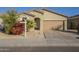 Tan colored single story house with attached garage and red flowering bush at 2838 W Apollo Rd, Phoenix, AZ 85041