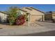 Single-story home with tan exterior, attached garage, and landscaping at 2838 W Apollo Rd, Phoenix, AZ 85041