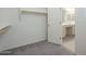 Spacious walk-in closet with built-in shelving and attached bathroom at 2838 W Apollo Rd, Phoenix, AZ 85041