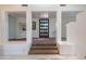 Elegant entryway with unique wooden door and tiled floor at 30600 N Pima Rd # 33, Scottsdale, AZ 85266