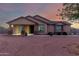 Single-story home with a covered porch and neutral color scheme at 30964 N Grace Ln, Queen Creek, AZ 85144