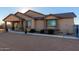 House exterior showcasing a covered porch and landscaping at 30964 N Grace Ln, Queen Creek, AZ 85144