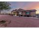 Front view of a house with a covered porch and desert landscaping at 30964 N Grace Ln, Queen Creek, AZ 85144