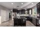 Spacious kitchen featuring dark cabinetry and granite countertops at 30964 N Grace Ln, Queen Creek, AZ 85144