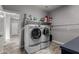 Bright laundry room with washer, dryer, and storage at 30964 N Grace Ln, Queen Creek, AZ 85144