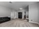 Living room with a dark wood cabinet and carpet flooring at 30964 N Grace Ln, Queen Creek, AZ 85144