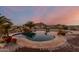 Kidney-shaped pool with waterfall feature at 30964 N Grace Ln, Queen Creek, AZ 85144